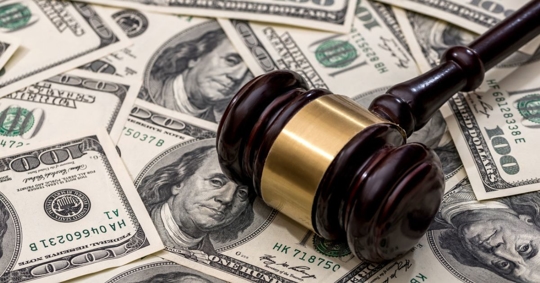 Gavel on top of $100 bills